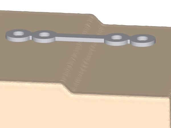 A linear strip plate is placed above a model in which there is a sinificant kink in the surface below it.