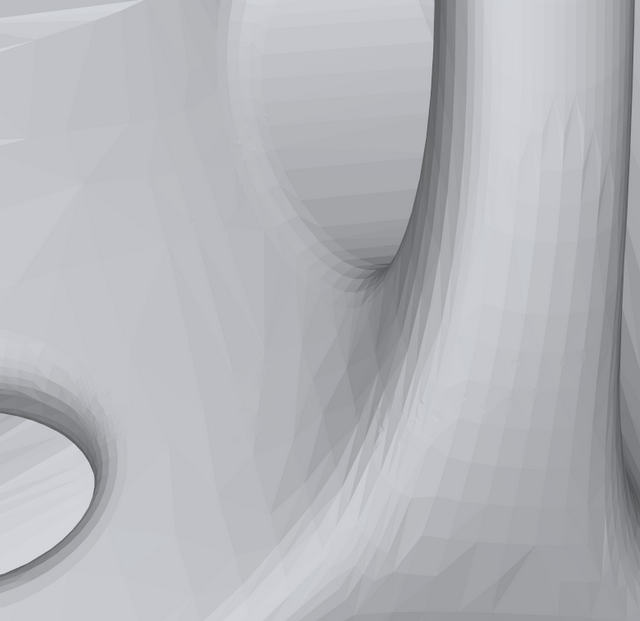 The text has been removed from the mesh model and the curved surfaces correctly restored.