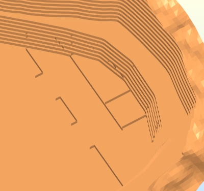 A mesh model of an open pit mine from above. Several thin linear walls are visible caused gaps between the boundaries of different extracted regions